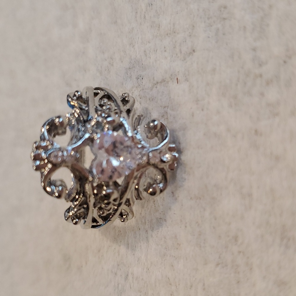 Tiny skulls with heart stone ring.